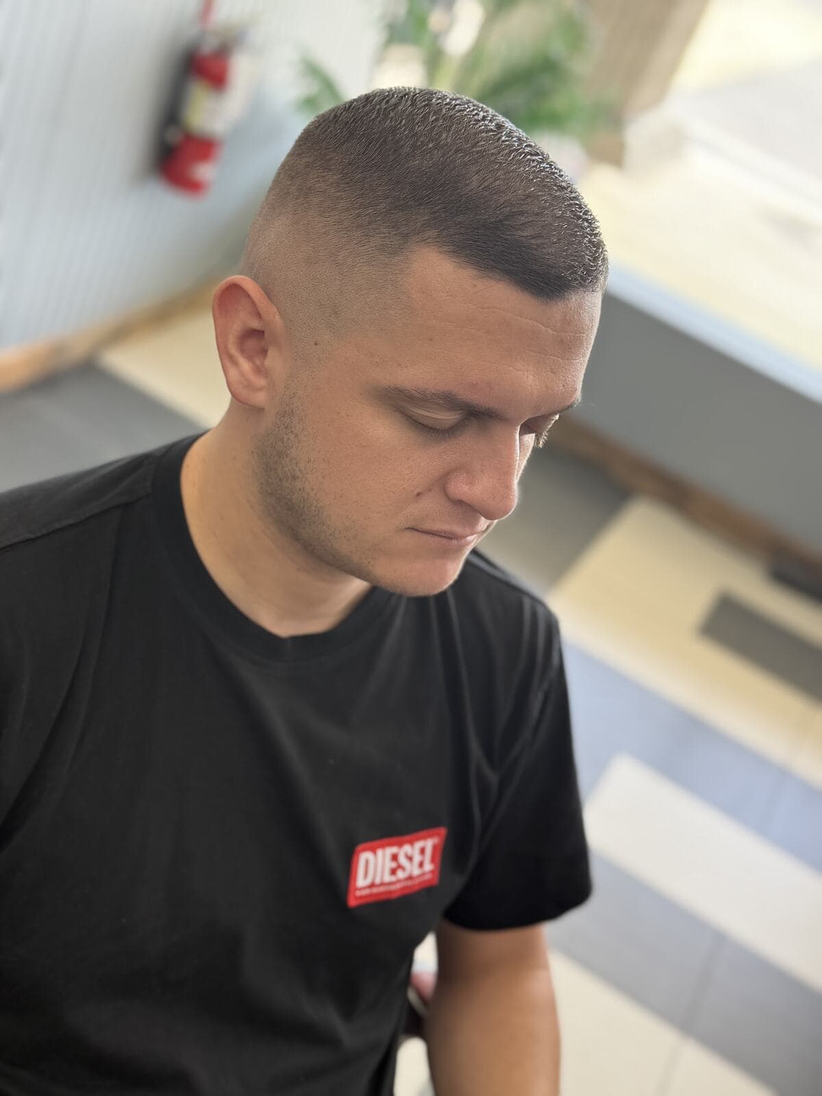 A client with a fresh short fade, just out of the chair