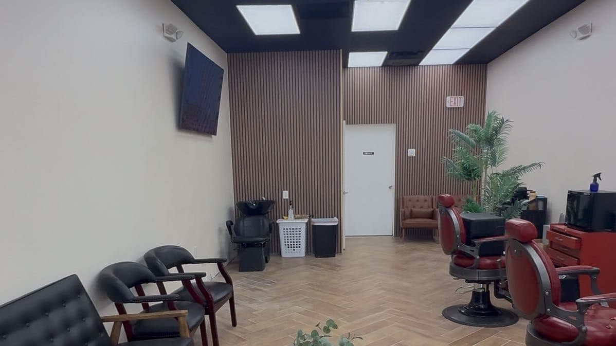 The seating area with leather chairs and a barber chair